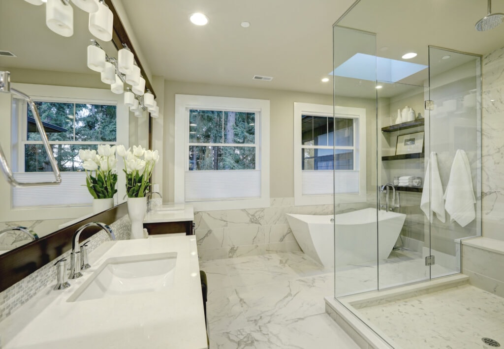 Luxury bathroom with double vanity and large window overlooking lush greenery, elegant design and light color palette, Perfect for relaxing and self-care routines, A serene and stylish bathroom setting from A Hundred Affections.
