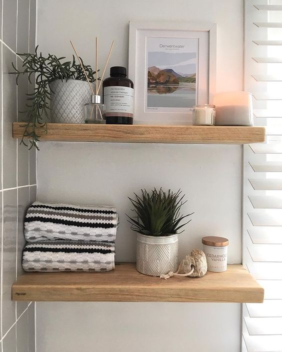modern farmhouse bathroom shelves with towels, picture, and decor