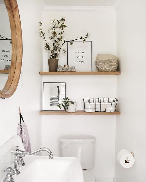 minimalist bathroom shelves over toilet with wire basket and sign black white