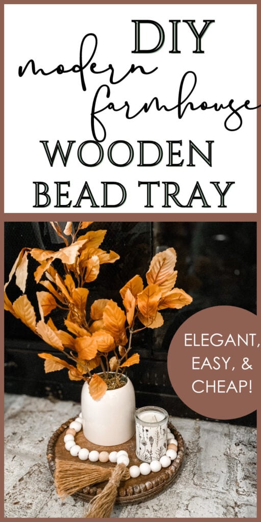 Vibrant orange faux leaves in a modern white ceramic vase styled with wooden bead tray and candle, perfect for DIY farmhouse decor, adding elegance, warmth, and rustic charm to home interiors.