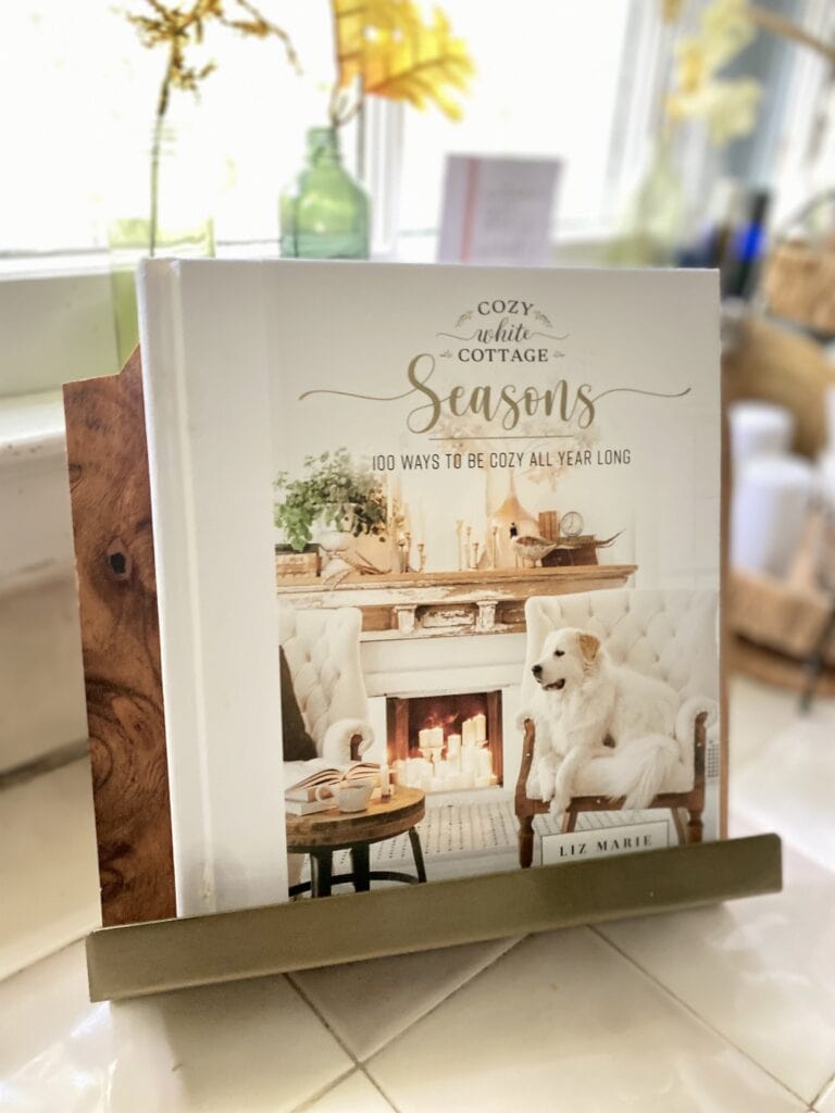 season liz marie galvin cozy white cottage book on cookbook stand