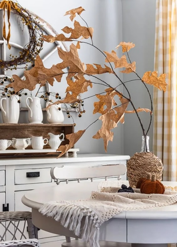 Golden dried leaf branch in a clear glass vase for rustic fall home decor - A Hundred Affections.
