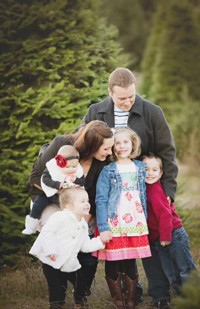 family at christmas tree farm for winter family photoshoot