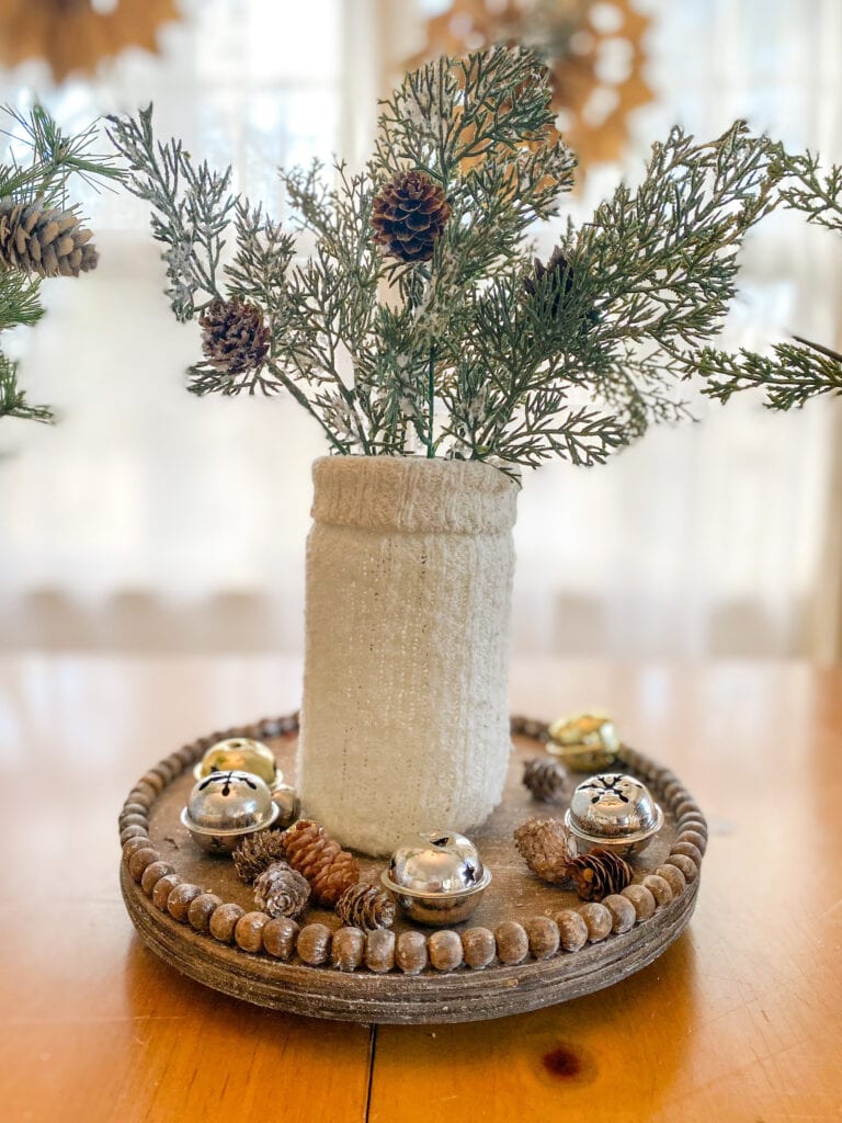 cream sweater over jar for diy vase craft with winter greens