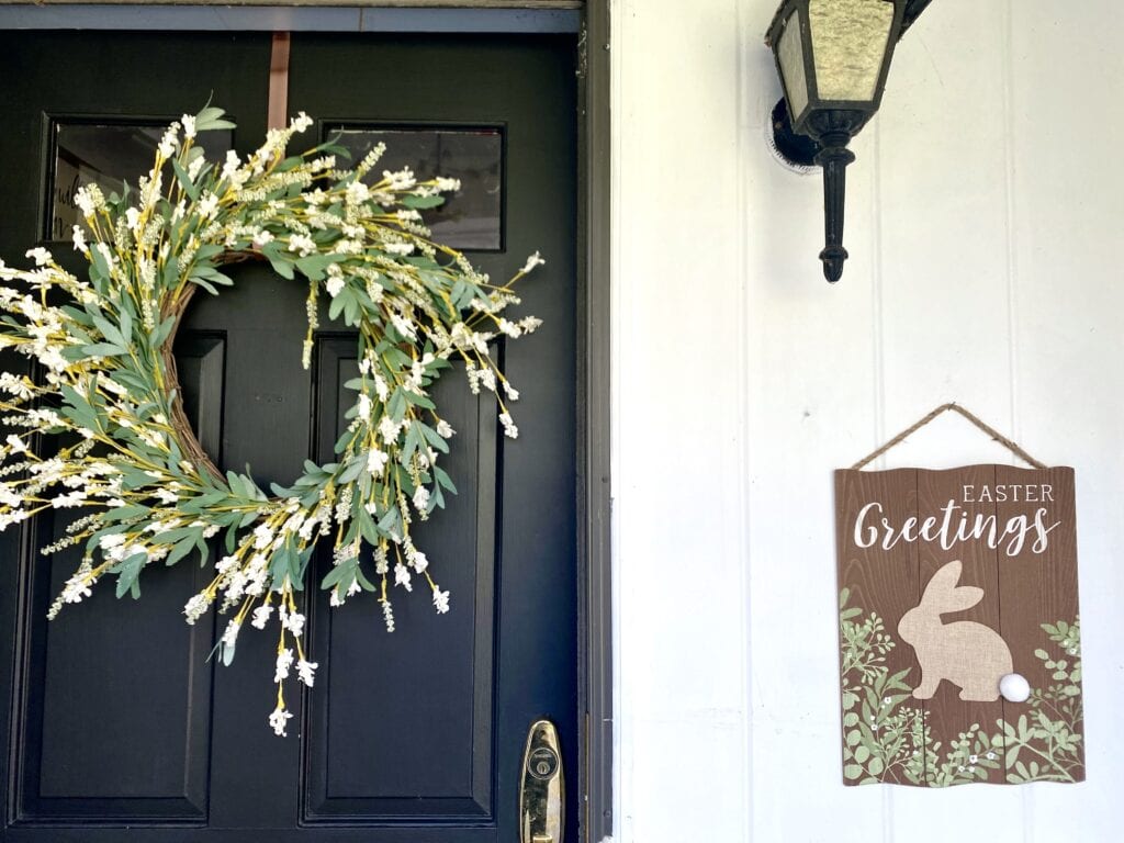 easter sign on porch wall with spring wreath