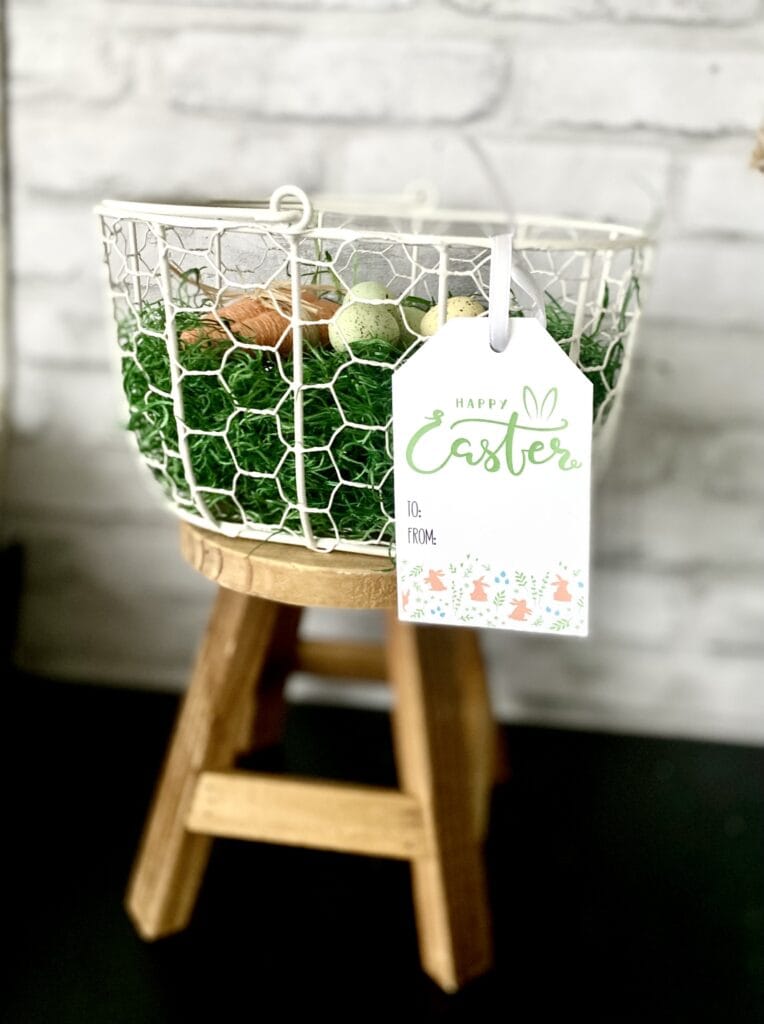free printable easter basket tag on white wire easter basket on stool