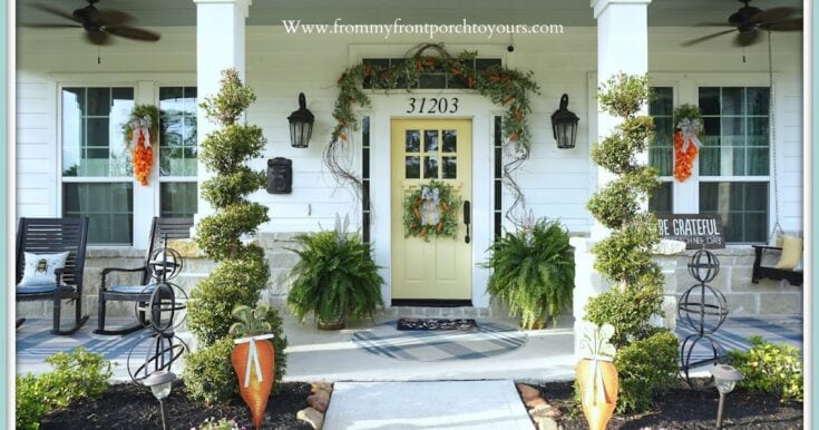 Decorated farmhouse porch with autumn wreaths, potted ferns, and cozy seating to enhance curb appeal and fall ambiance for a welcoming home exterior.