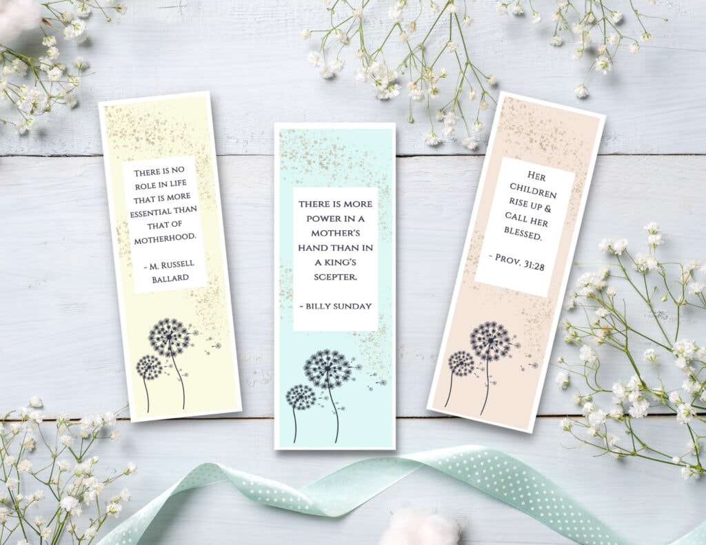pink yellow blue mother's day printable bookmarks with quotes on blue background with baby's breath and ribbon 