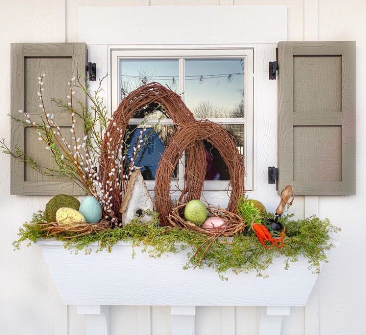 Easter floral and wreath arrangement on a window box with spring decor, eggs, greenery, and rustic accents for seasonal home decoration.