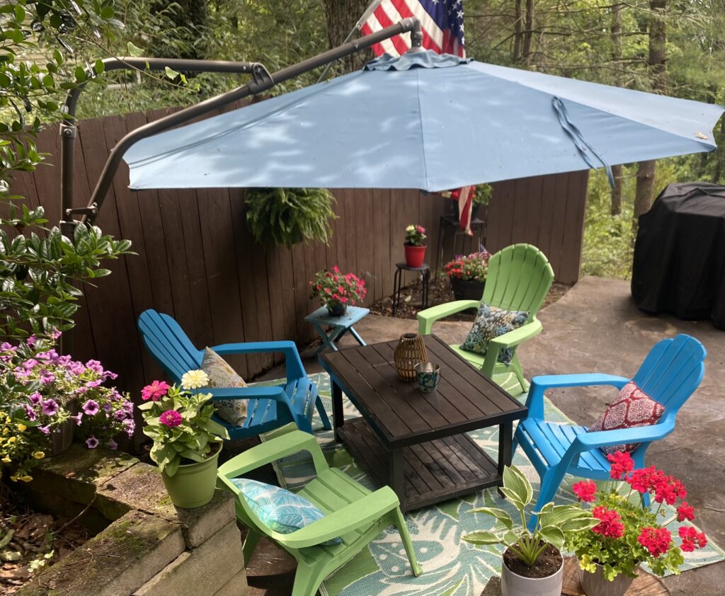 top view patio garden with bright chairs umbrella rug flowers