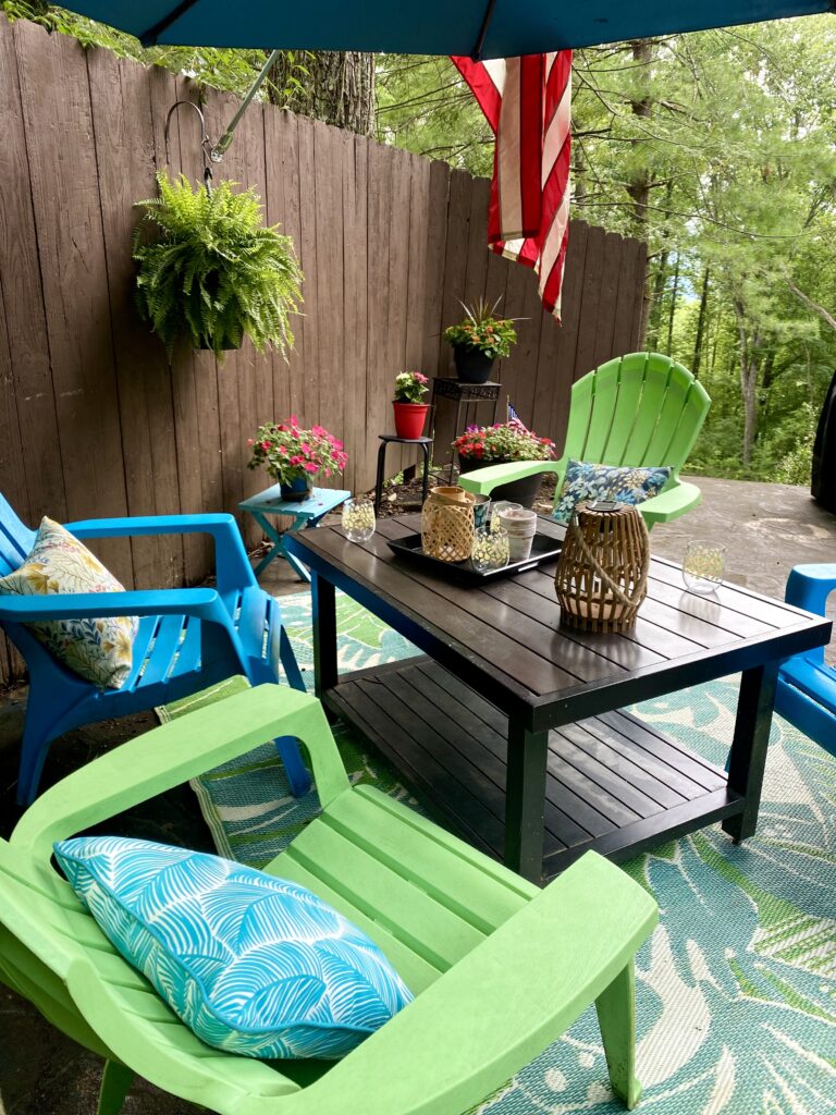 outdoor seating area on patio with bright adirondack chairs
