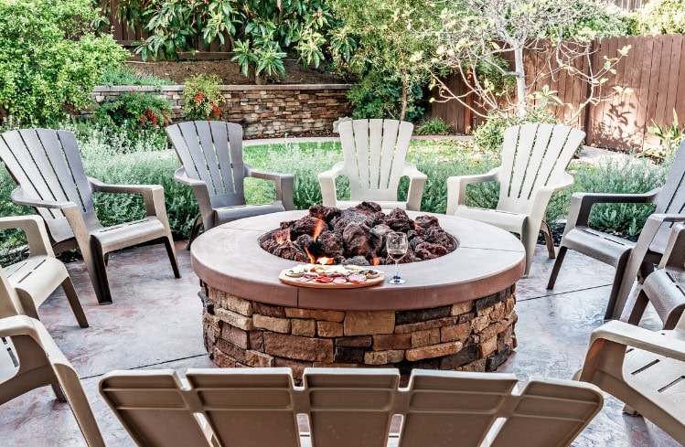 adirondack chairs around firepit on patio