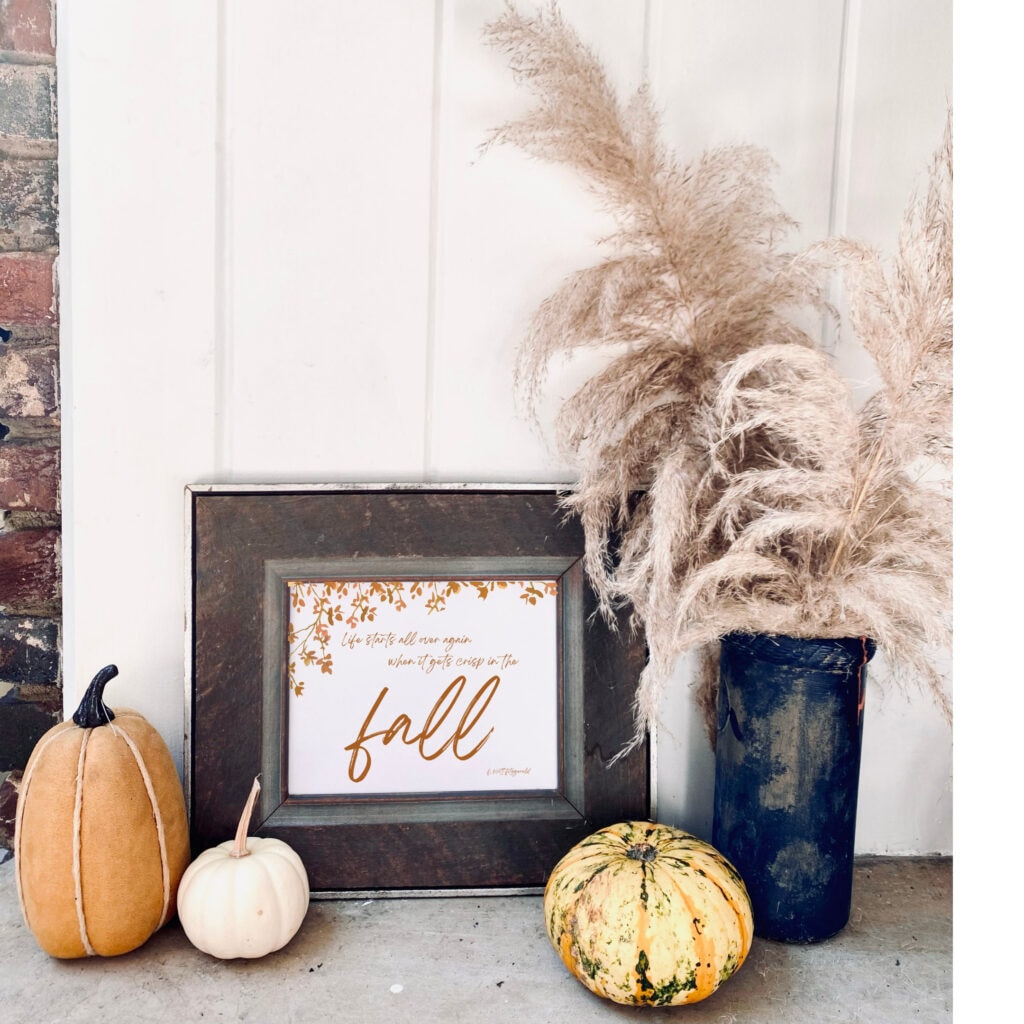 Soft fall decor with dried pampas grass in a black vase, pumpkins, and a framed quote, perfect for autumn home decor and seasonal styling.