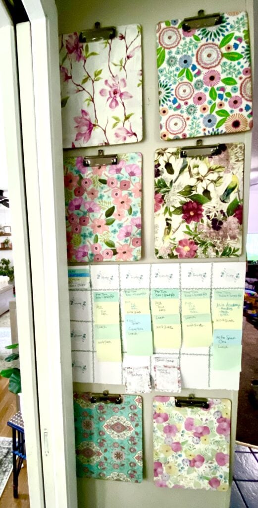 Floral patterned clipboards wall decor, colorful flower designs, organization with magnetic clips, decorative and functional home or office solution.