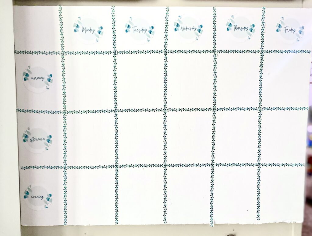 foam board weekly planner with washi tape and post it notes for family command center