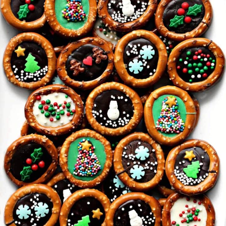 Colorful holiday chocolate cupcakes decorated with festive sprinkles, Christmas trees, snowmen, and holly, perfect for seasonal celebrations and holiday parties.