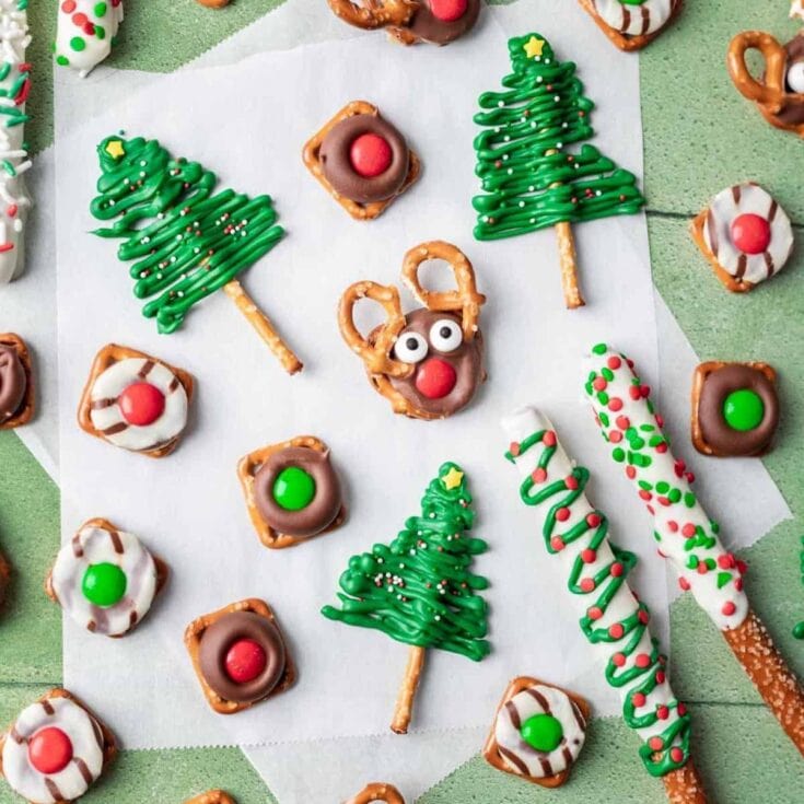 Festive Christmas cookies decorated as trees, reindeer, and candy canes with colorful sprinkles and icing, perfect for holiday celebrations and gifting.