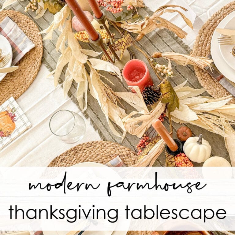 Rustic autumn-themed Thanksgiving tablescape with fall foliage, candles, pumpkins, and woven placemats for modern farmhouse decor.
