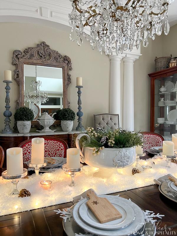 Bright, sophisticated dining room featuring a luxurious chandelier and ornate mirror.