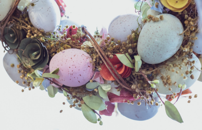 easter wreath with embellishments and pastel eggs