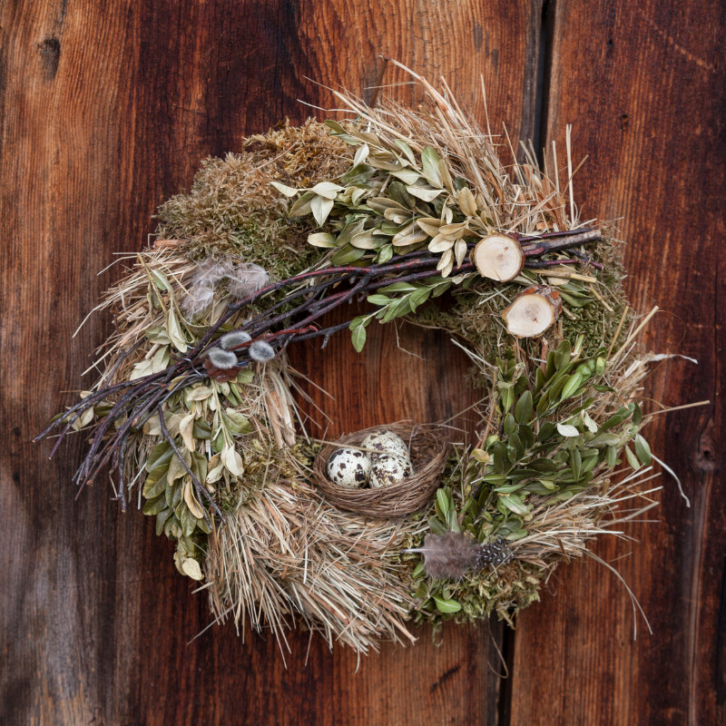 nature inspired wreath with feeather and birds nest