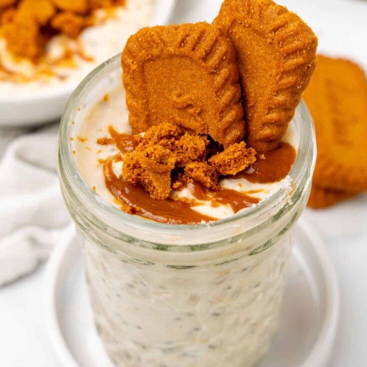 Golden fried chicken breast on creamy biscuit and butter mashed potatoes in a glass jar with caramel syrup drizzled on top.