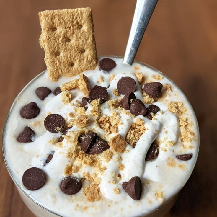 Creamy milkshake topped with chocolate chips, crushed cookies, and a crispy cracker for indulgent dessert enjoyment. Perfect for satisfying sweet cravings and enjoying a delicious treat.