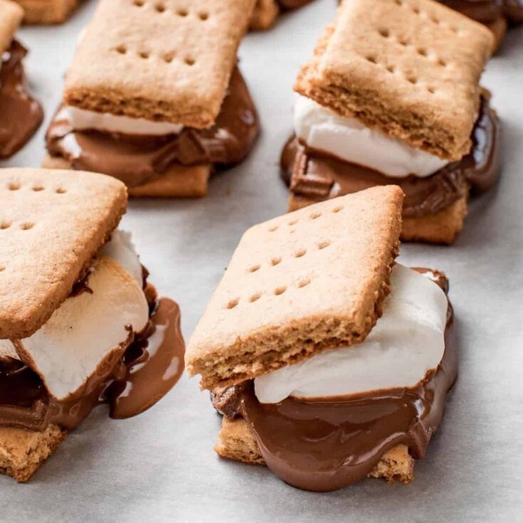 Cream-filled chocolate s'mores with graham crackers and marshmallow; delicious dessert treats perfect for summer and camping.