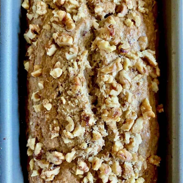 Sweet nut-topped banana bread loaf with a crunchy walnut crust, perfect for cozy mornings and dessert cravings, highly shareable with family and friends.