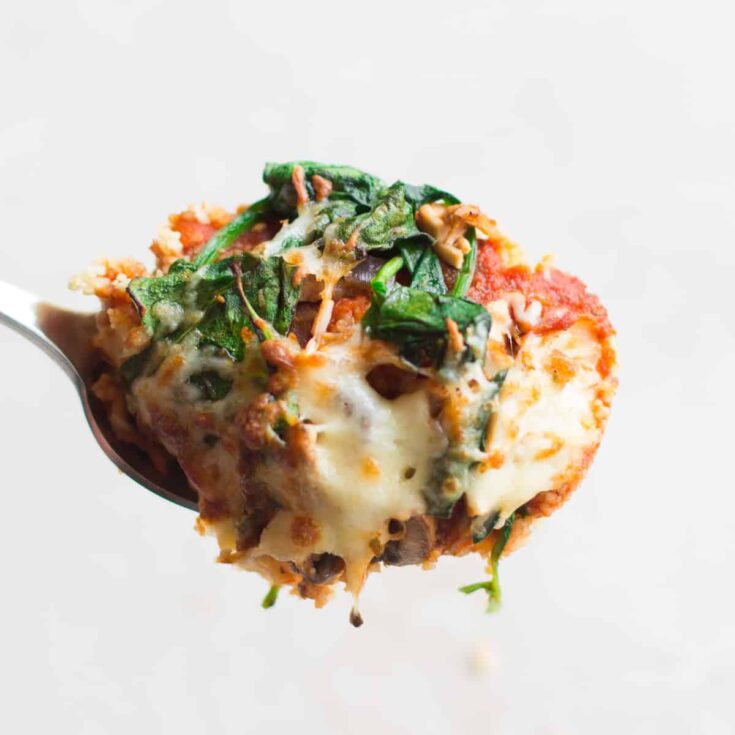 Creamy spinach and mushroom stuffed pizza slice with melted cheese, crispy crust, and savory toppings, perfect for comfort food lovers and pizza enthusiasts.