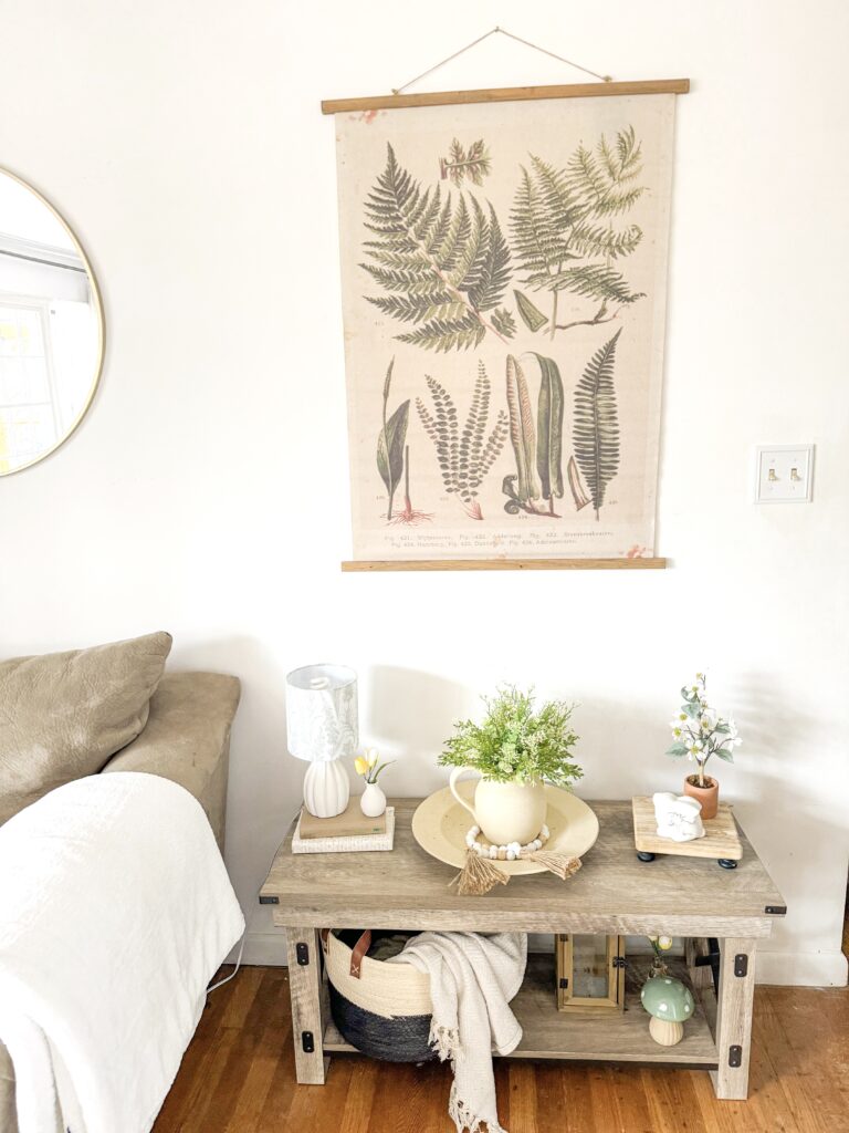 spring tapestry with vintage botanicals, rustic bench with thrifted textured pitcher and bowl, faux greens, floral lamp, spring decor