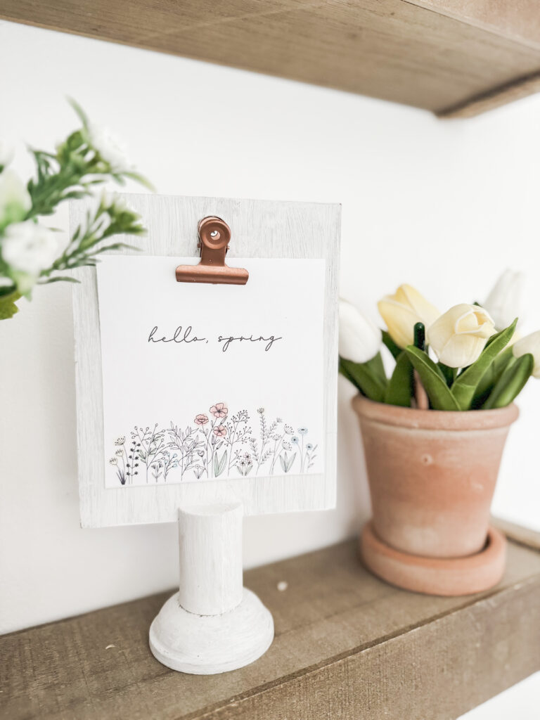 hello spring on clipboard stand for spring free printable wall art