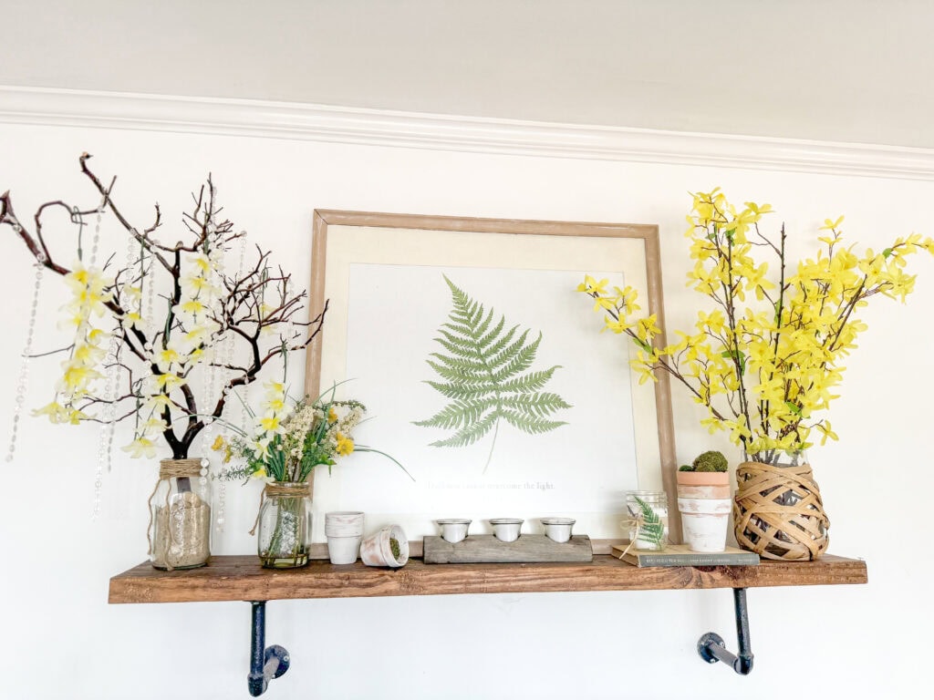 shelf with manzanita tree, rhinestones, faux florals dripping, fern wall art, faux forsythias and garden decor