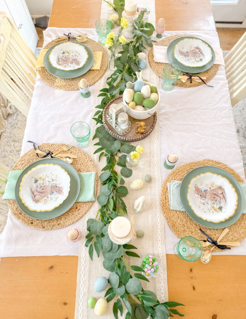 easter table with varying spring pastel linen napkins, bunny plate place setting top view, ceramic basket centerpiece