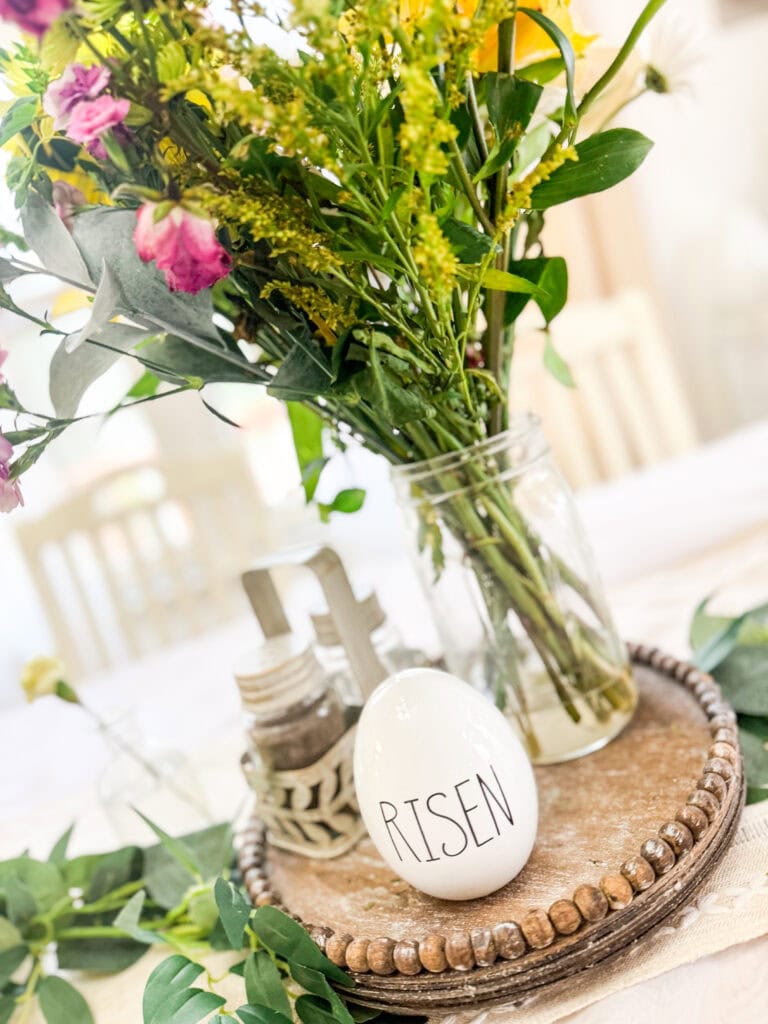 fresh flowers in mason jar with risen egg for easter centerpiece