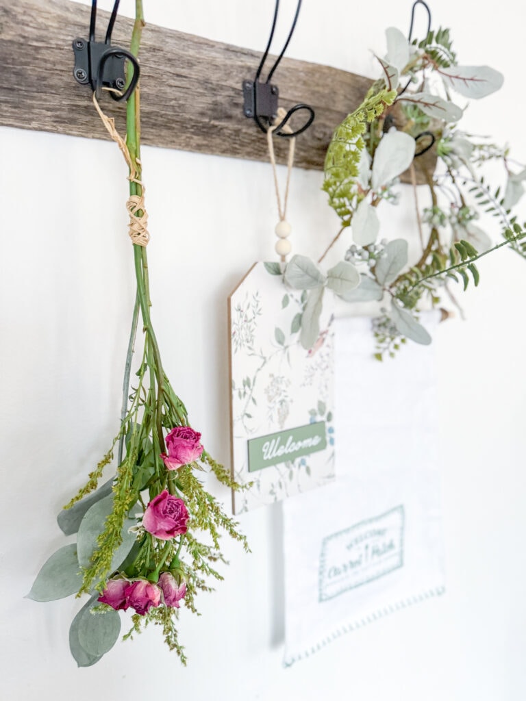 floral hook board with dried flowers wreaths, signs in cottagecore aesthetic