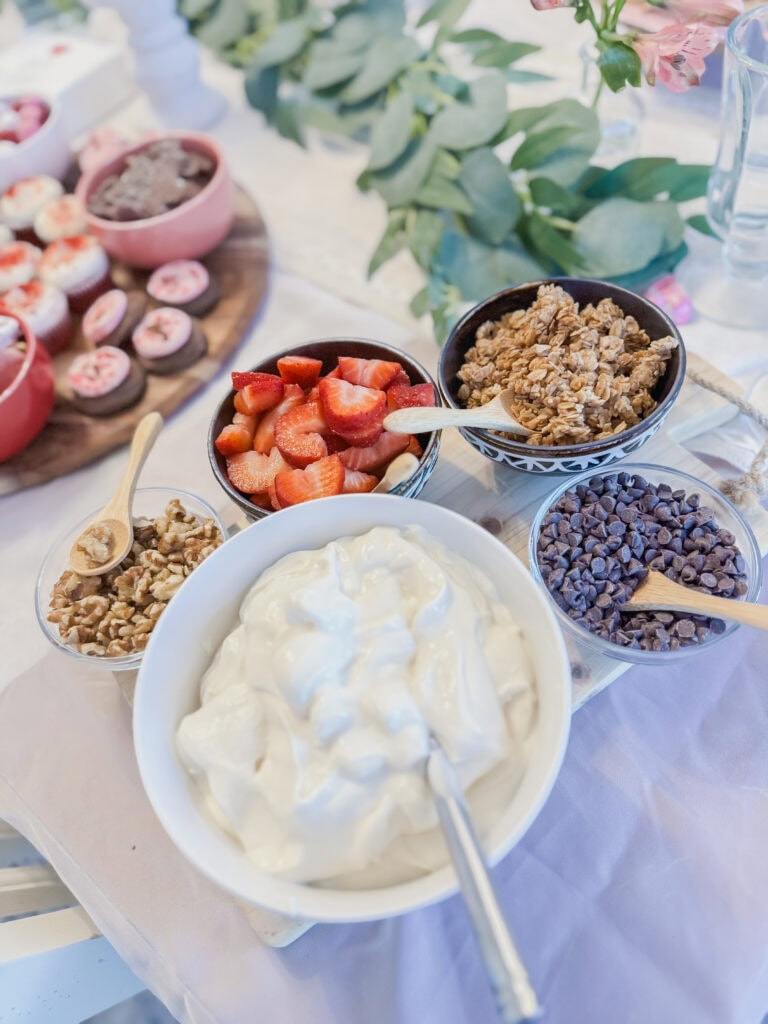 yogurt parfait stations with yogurt and different toppings mix ins for galentine's day treats