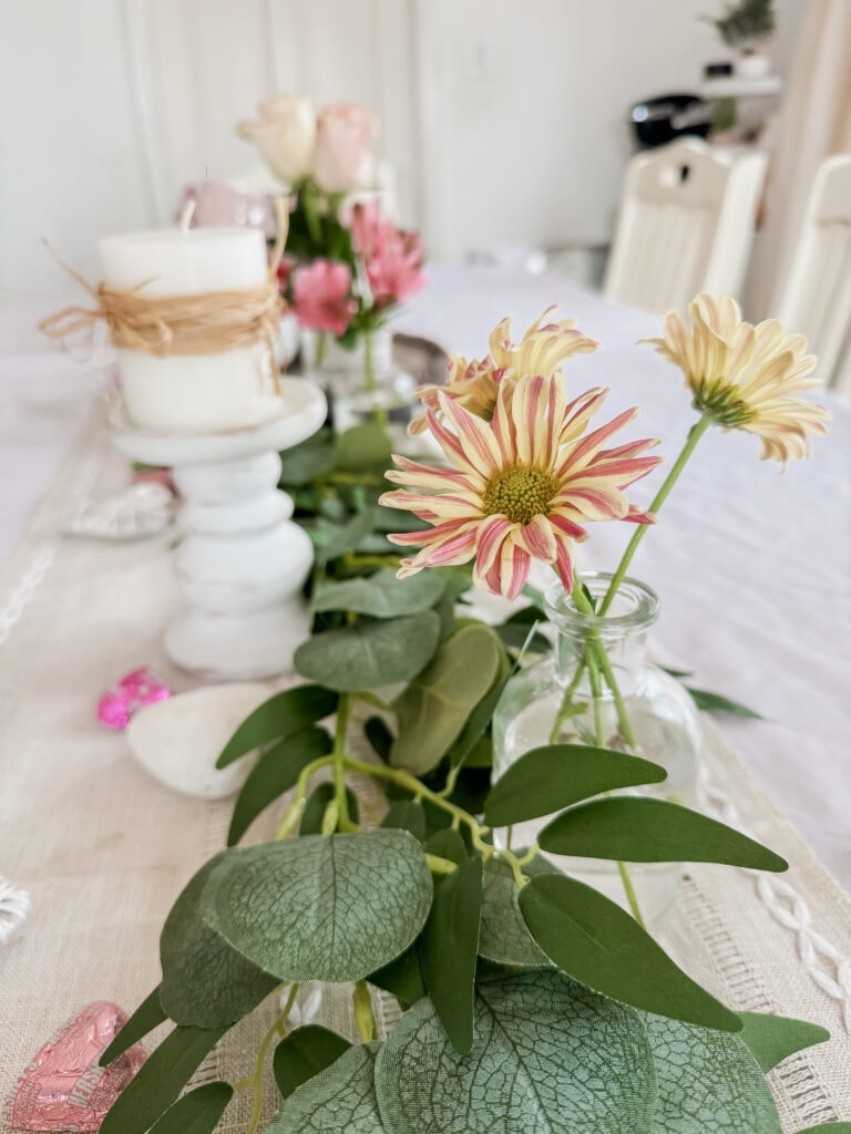 valentine bud vases on table with flowers