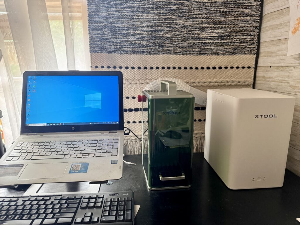xtool f1 on desk next to laptop
