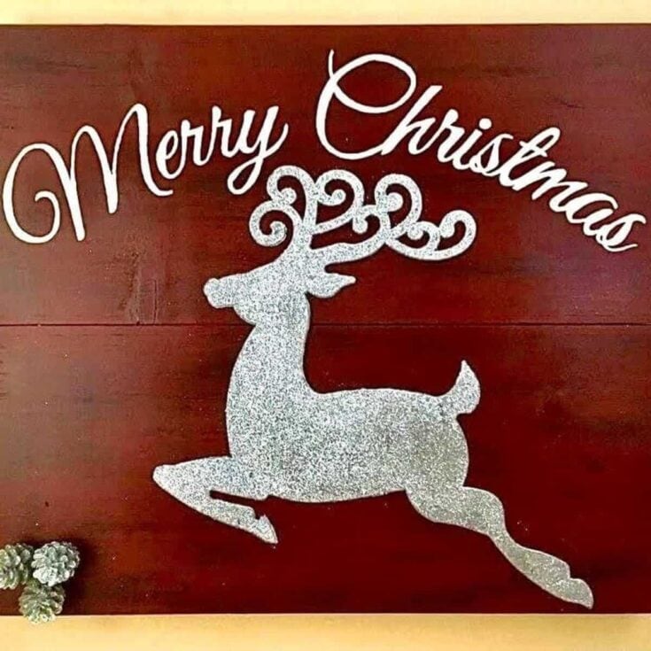 Sparkling silver glitter reindeer with antlers forming the words "Merry Christmas" in elegant white script on a warm wooden background, perfect for holiday decor and Christmas celebrations.