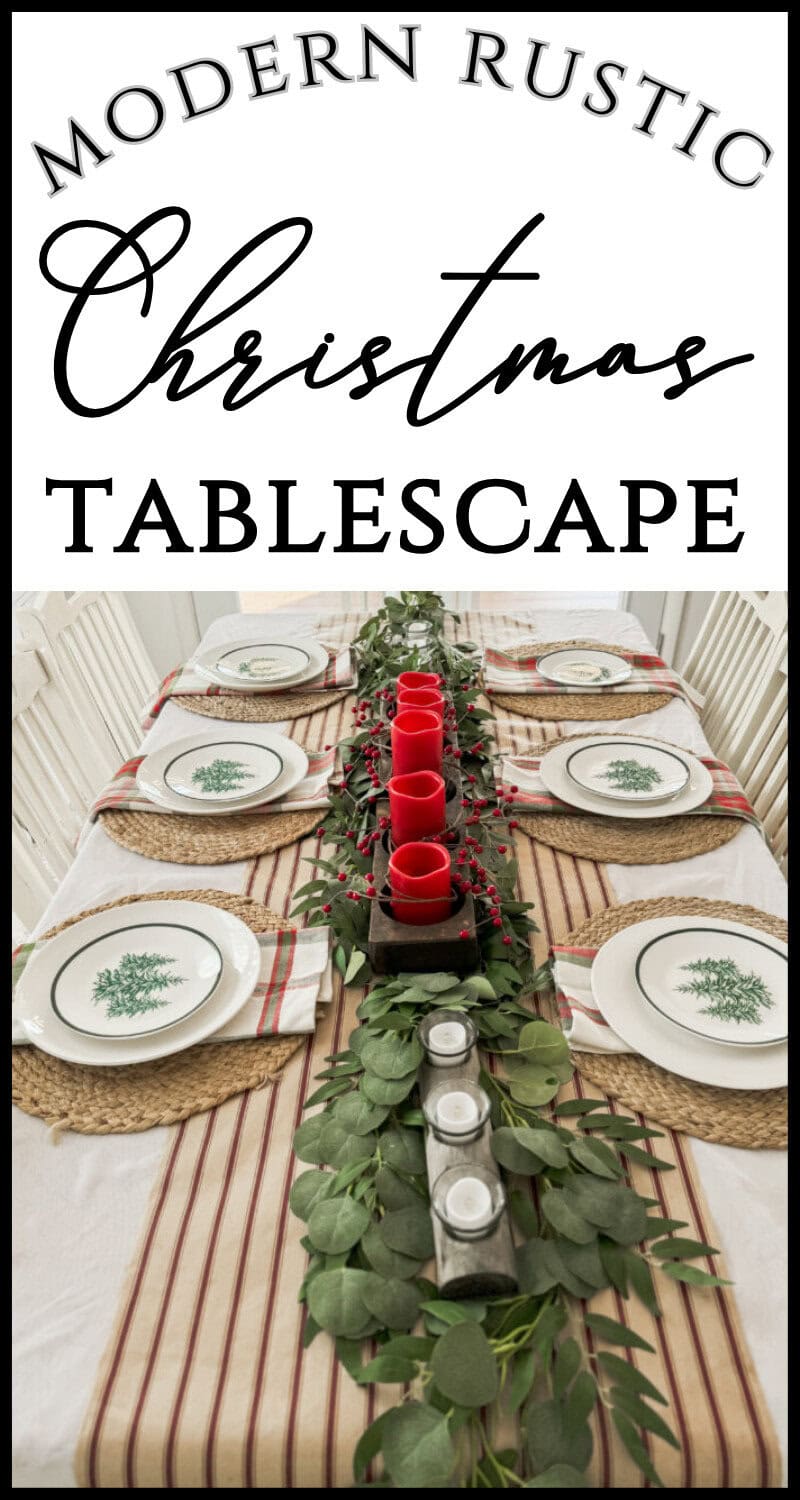 Rustic modern Christmas tablescape with red candles, greenery, and festive tableware for holiday gatherings.