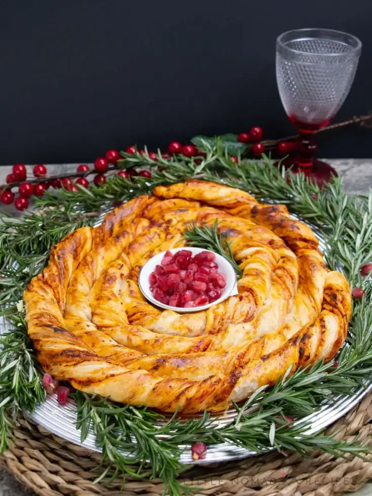 Savory holiday spiral rosemary bread with cranberries on a decorative platter. Perfect for festive gatherings and special occasions at A Hundred Affections.