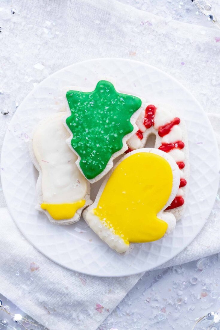 Festive holiday sugar cookies decorated with green, yellow, white, and red icing, perfect for Christmas celebrations.