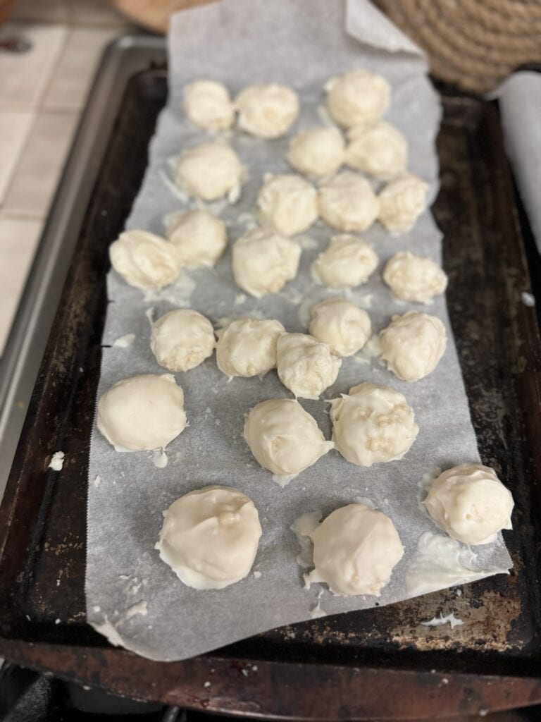 coconut snowballs candy on parchment paper