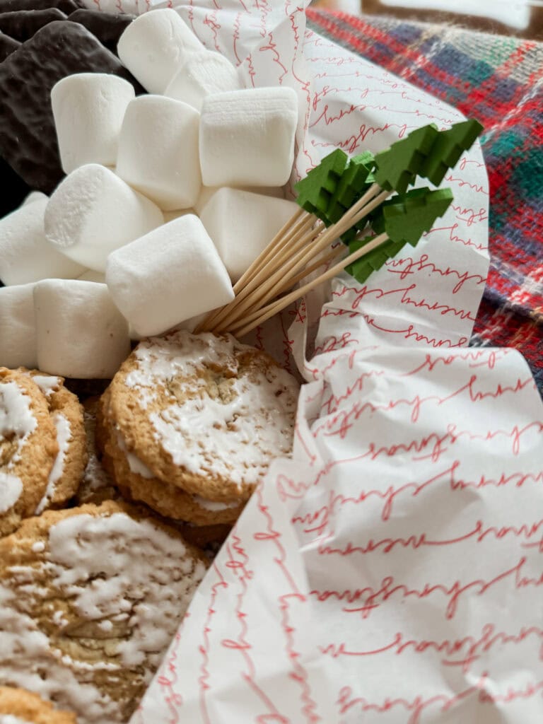 white marshmallows and oatmeal cookie on smores christmas board