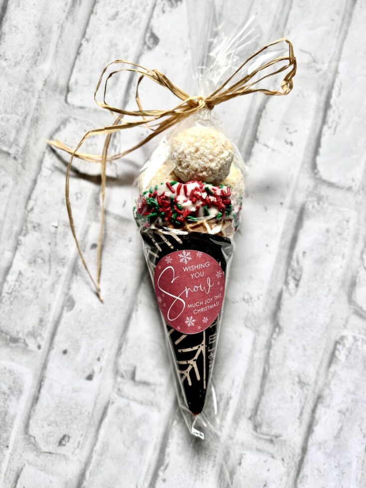 Sweet holiday gift of assorted Christmas cookies and treats in clear wrapping with a festive "Wishing You Snow Much Joy This Christmas" tag.