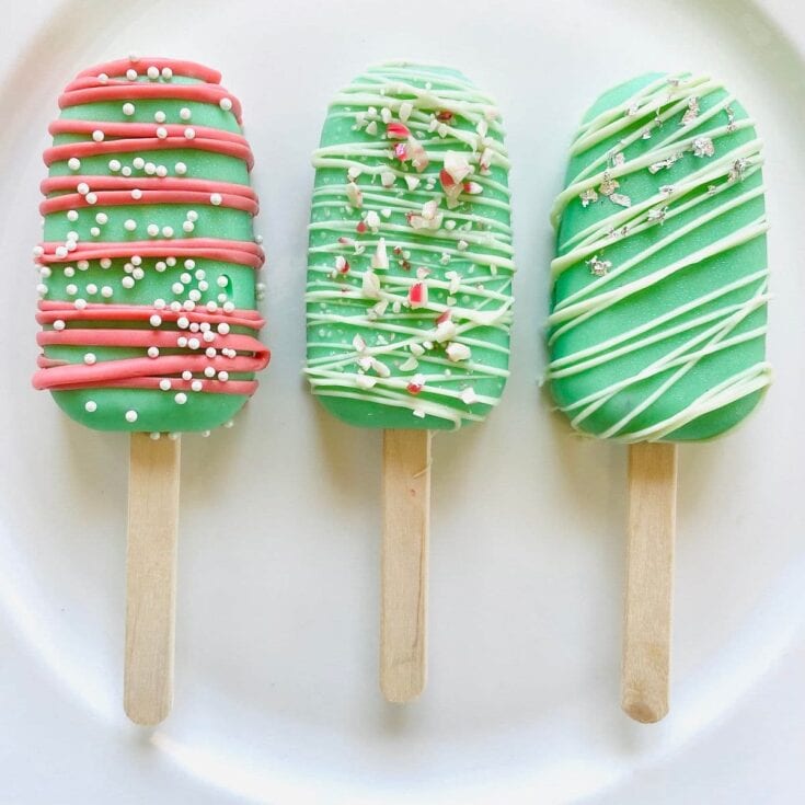Colorful holiday-themed popsicle desserts decorated with white, red, and silver sprinkles, ideal for festive occasions and special treats.