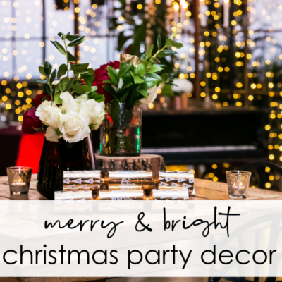 christmas party decorations with fairy light curtains on window, christmas shakers and flowers on table