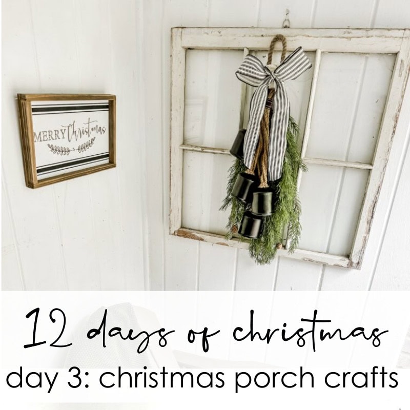 Festive Christmas porch decor with greenery, bells, and rustic wood window frame for holiday home decoration.