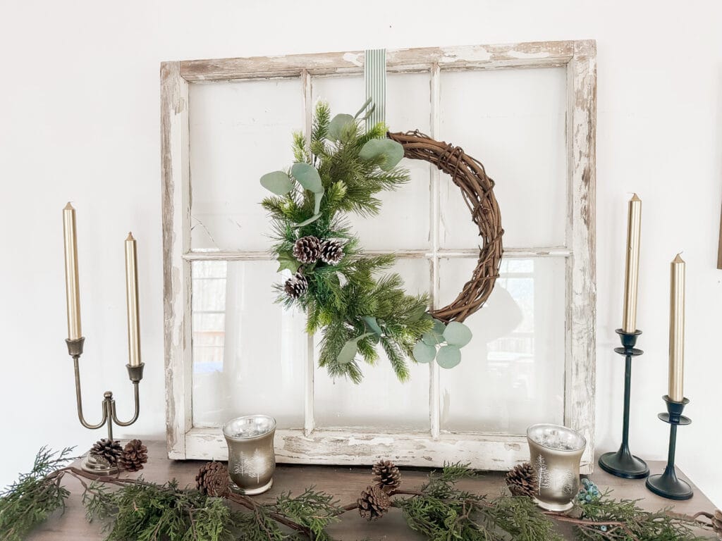 winter wreath on rustic window with candles for winter home decor